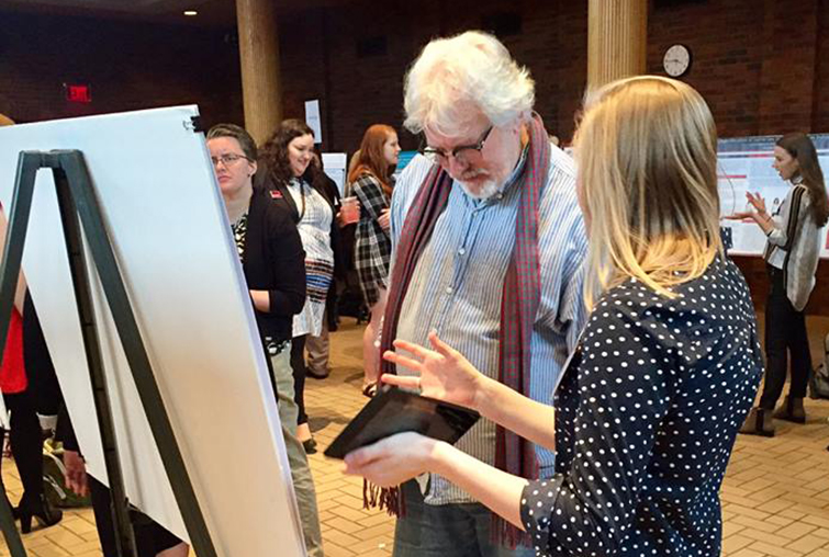 A student and professor chat at the annual Zyzzogeton event